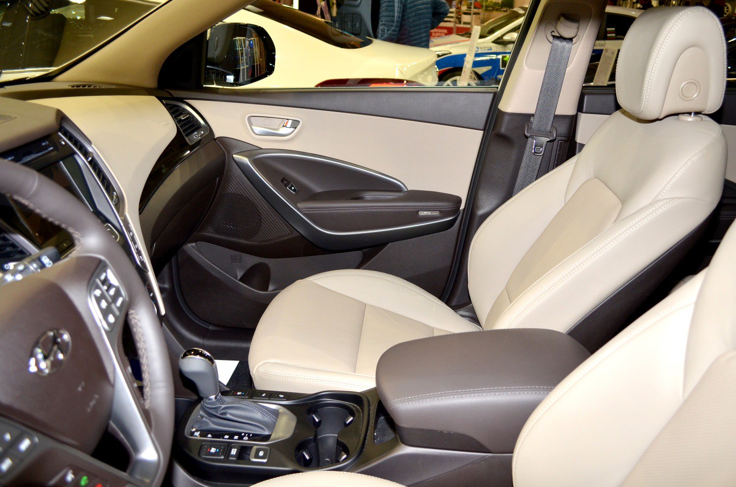 Beige leather front seat and modern dashboard with gear shift