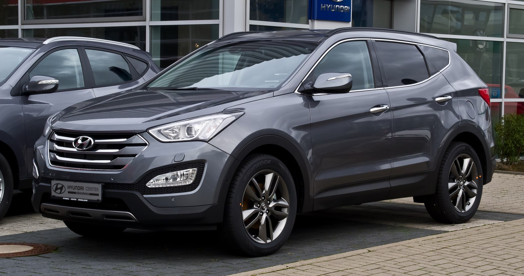 Front and side exterior of mid-size SUV with alloy wheels and modern grille