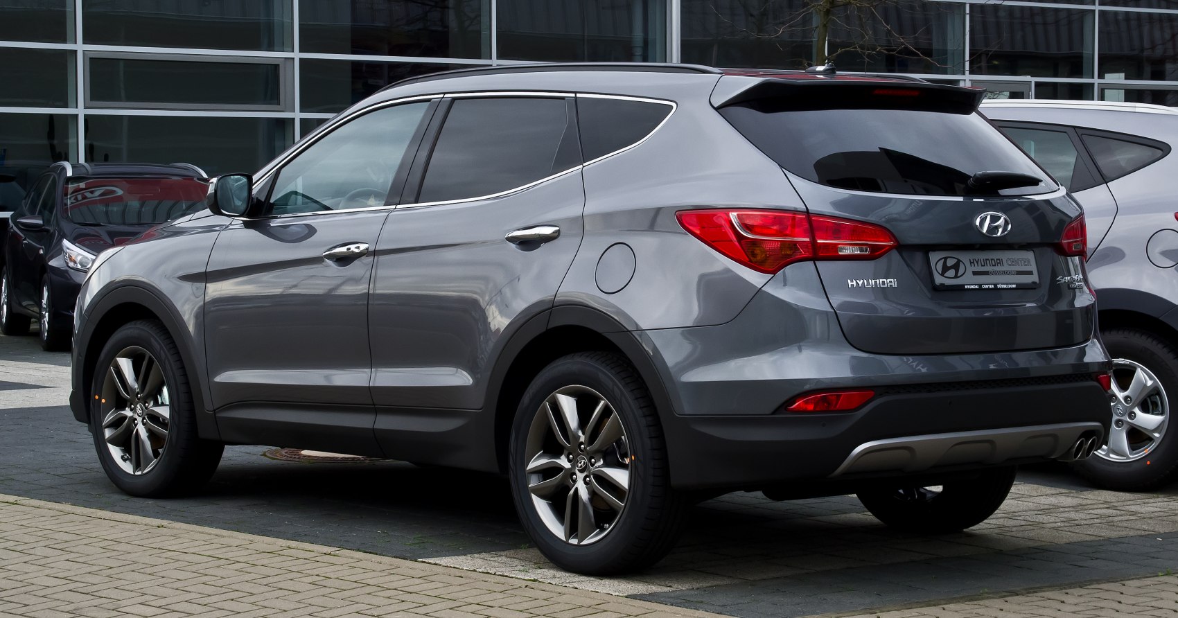 Gray modern SUV rear three-quarter view with alloy wheels and tinted windows
