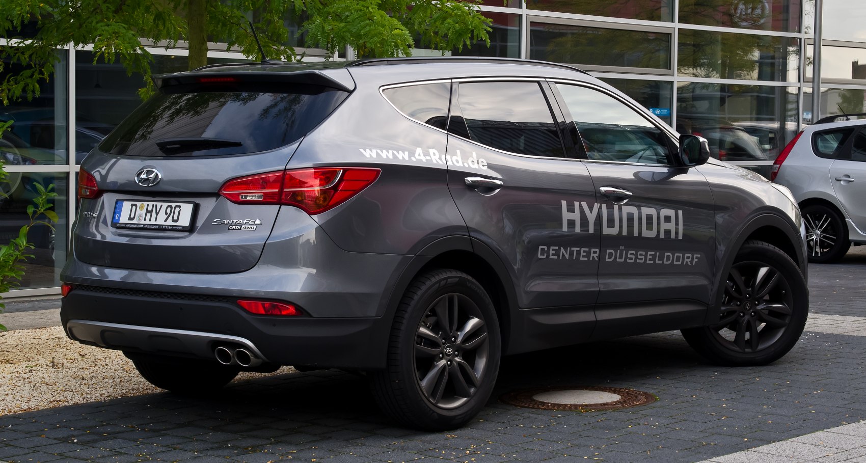Rear side view with dual exhaust and alloy wheels