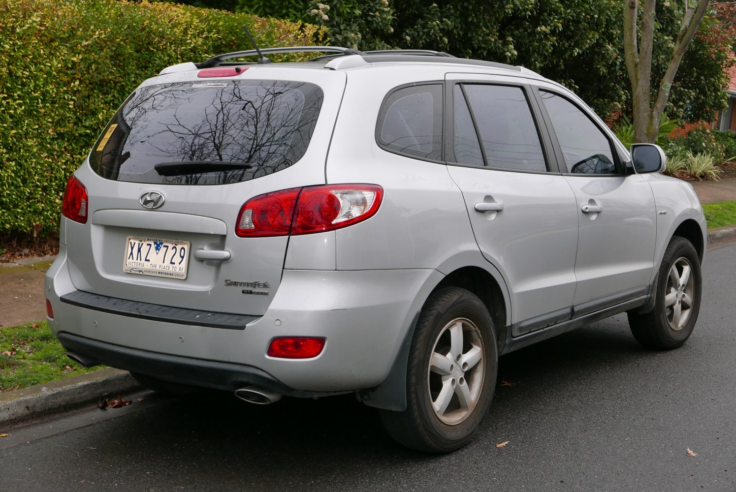 Rear side view of silver SUV with roof rails and alloy wheels