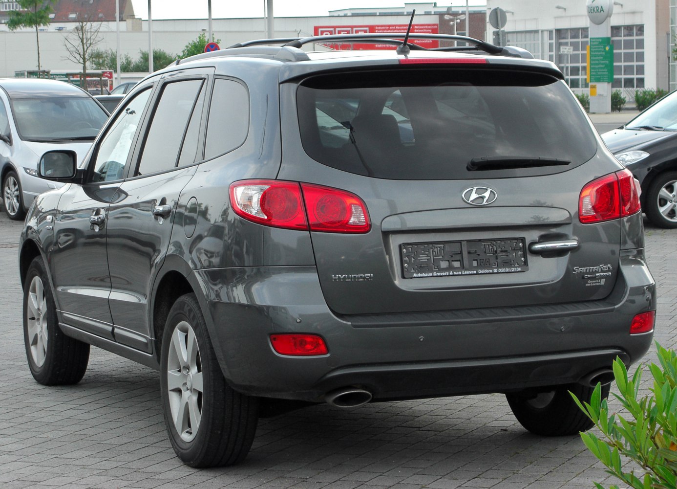 Rear view of SUV with tail lights, rear window, and dual exhaust