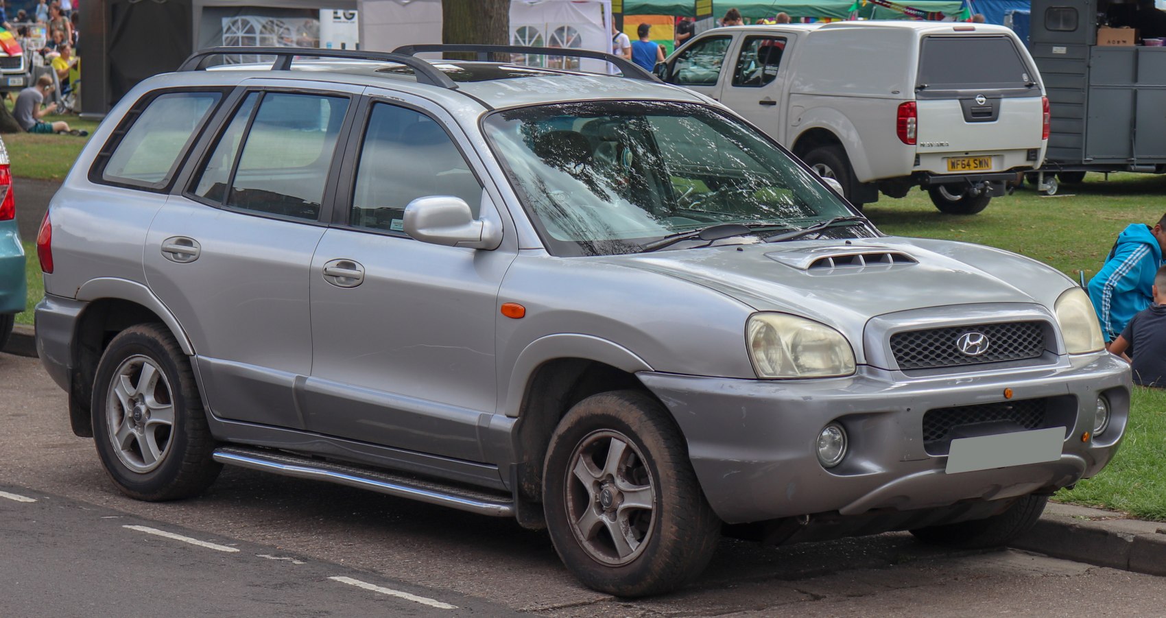 SUV with hood scoop, roof rails, alloy wheels, and robust design