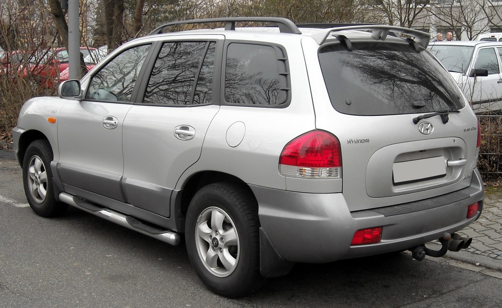 Silver SUV rear side view with roof rails and alloy wheels