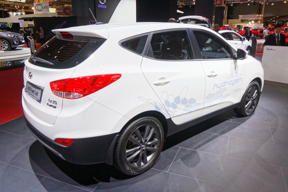 White hydrogen fuel cell SUV rear and side view with decals and alloy wheels