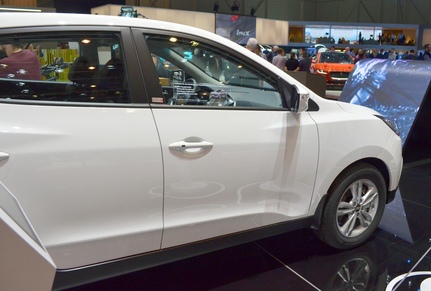 Side profile showing doors and alloy wheels of white SUV