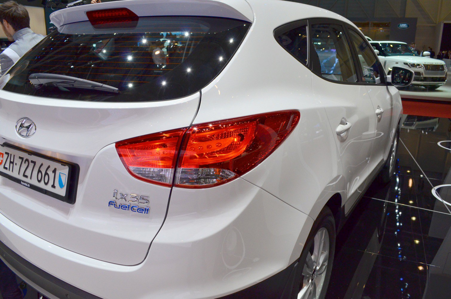 Rear side of white SUV showing taillights and FuelCell badge