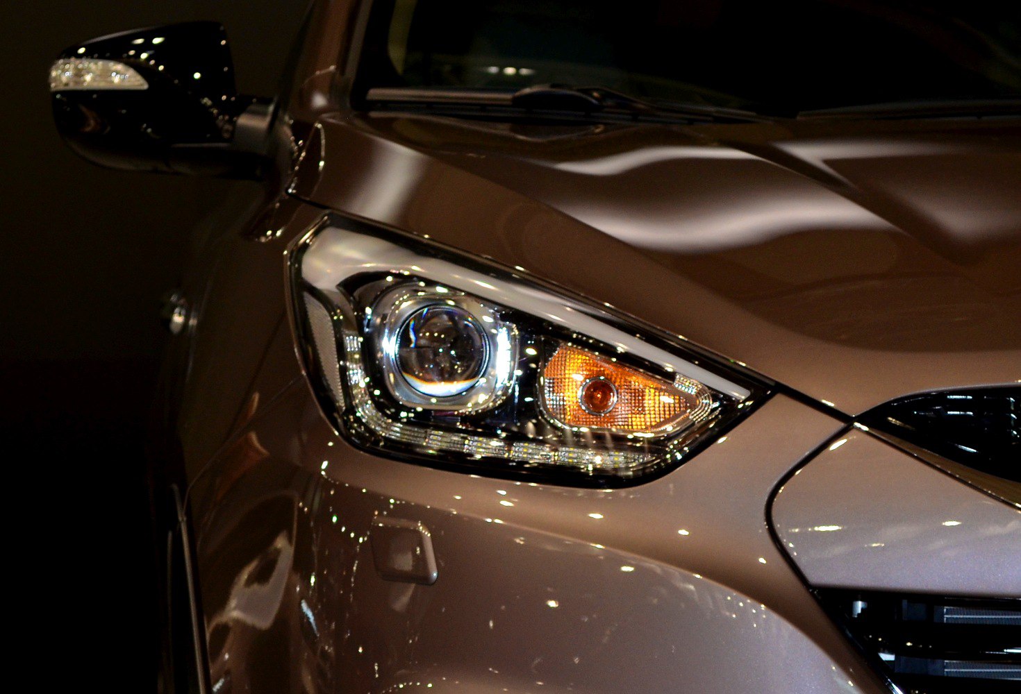 Close-up of front headlight and turn signal on car bonnet