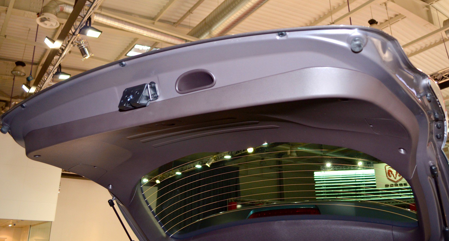 Rear hatch interior with window defroster lines and latch mechanism.