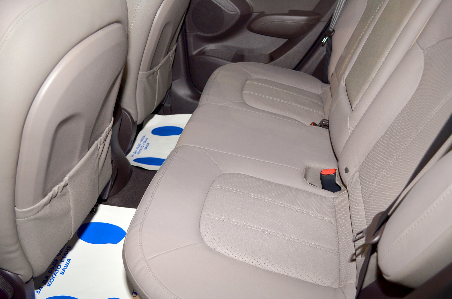 Beige rear seat interior with spacious and comfortable design.