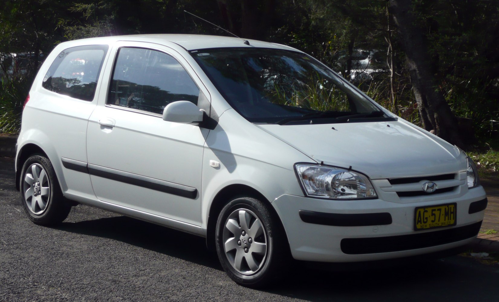 Compact 3-door hatchback front-side view with alloy wheels.