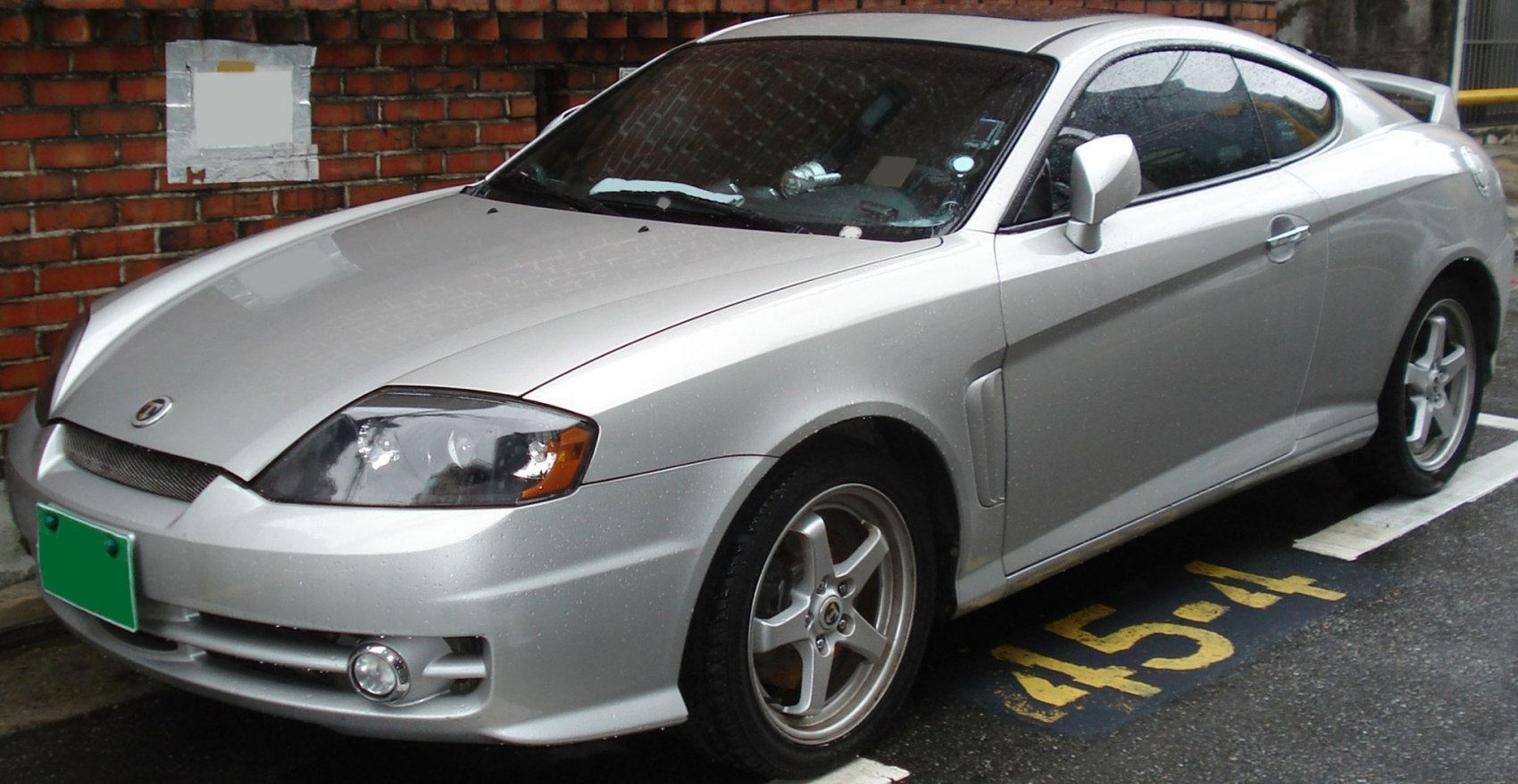 Silver sporty coupe with aerodynamic body and 5-spoke alloy wheels