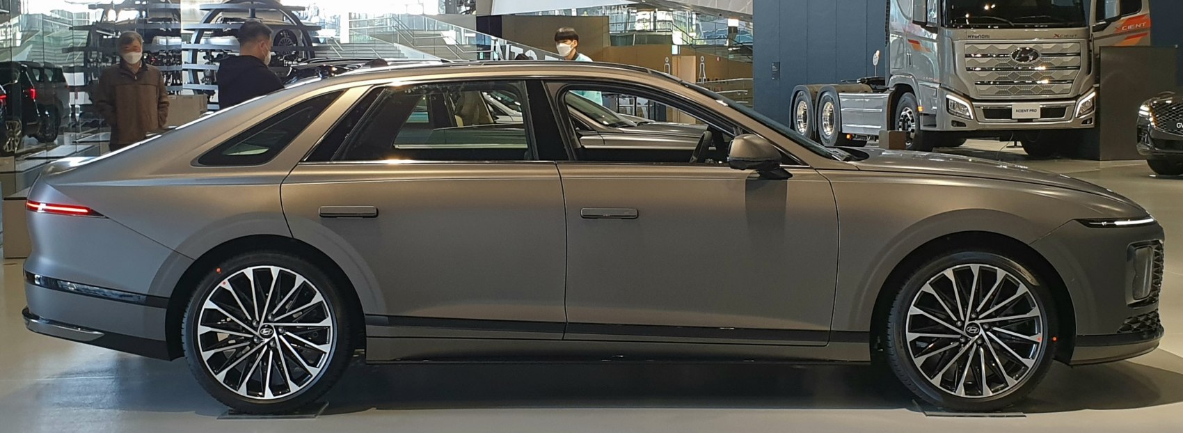 Futuristic LED lights and multi-spoke alloy wheels on sleek sedan side profile