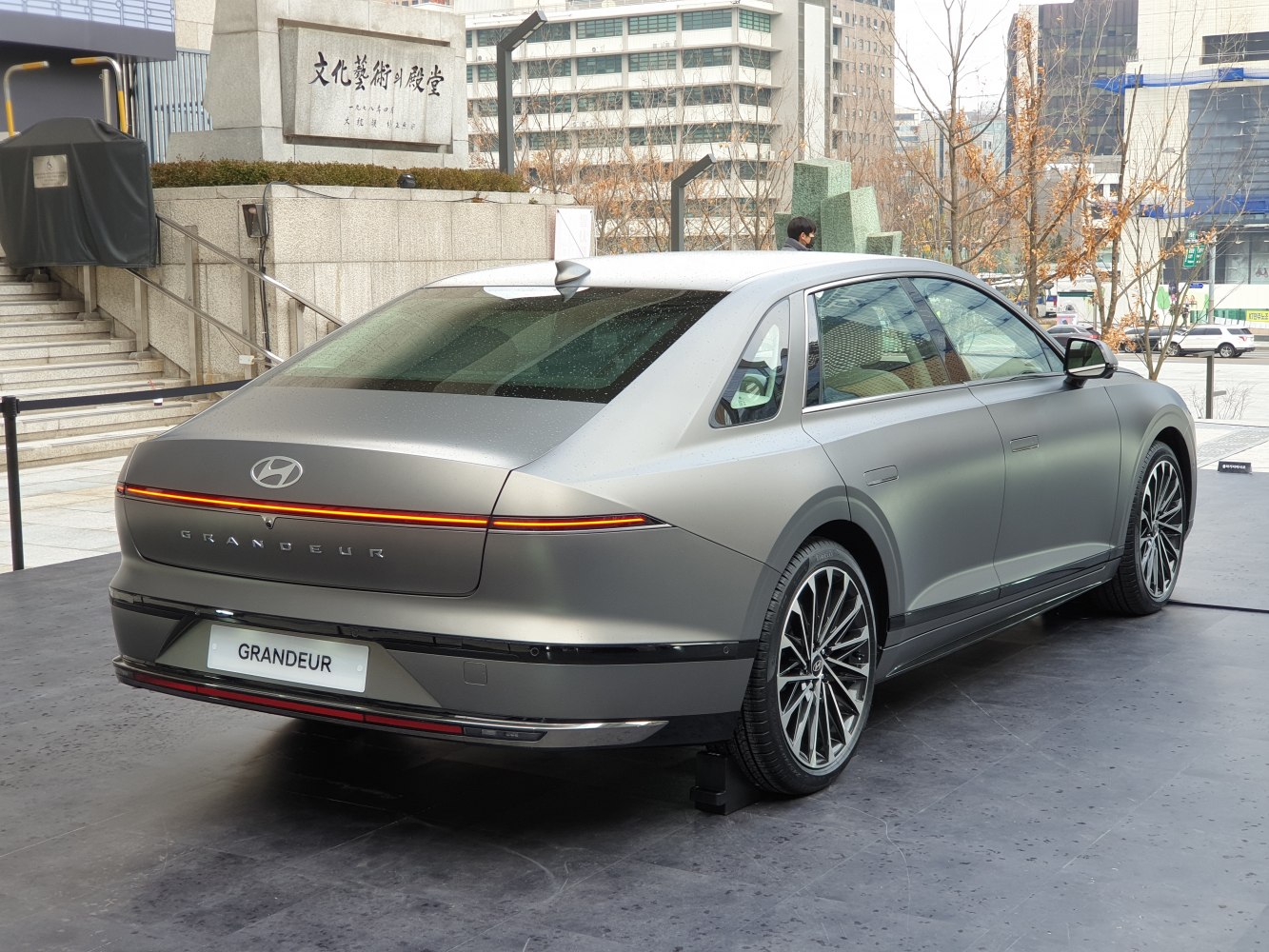 Sleek rear design with continuous LED tail light strip on luxury sedan.