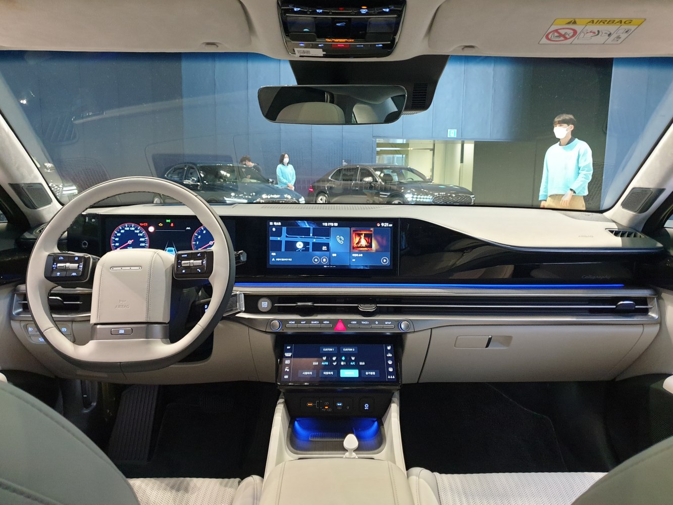 Digital dashboard with ambient blue lighting and multi-screen infotainment