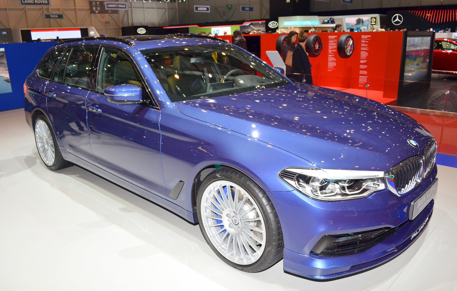 Blue station wagon with multi-spoke alloy wheels and LED headlights
