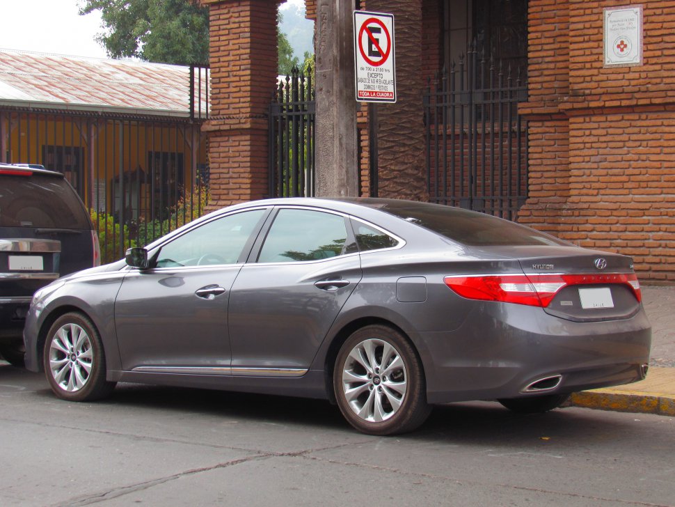 Side and rear view of a sleek gray mid-size sedan with distinctive taillights and alloy wheels