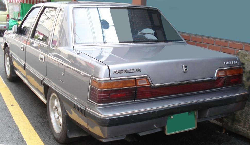 Rear and side view of a classic four-door sedan with rectangular taillights and chrome trim