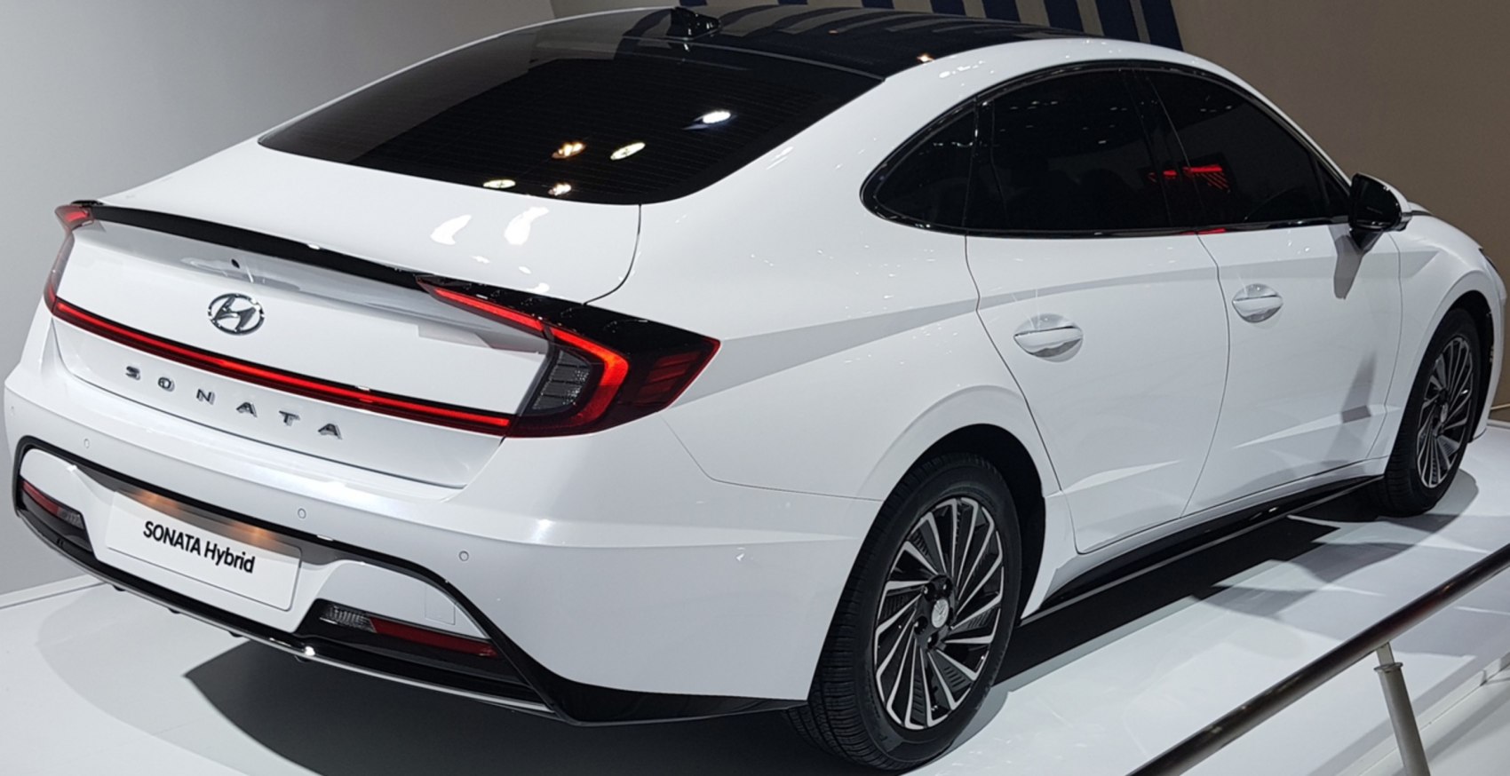 Rear and side view of a sleek sedan with LED taillights and aerodynamic design
