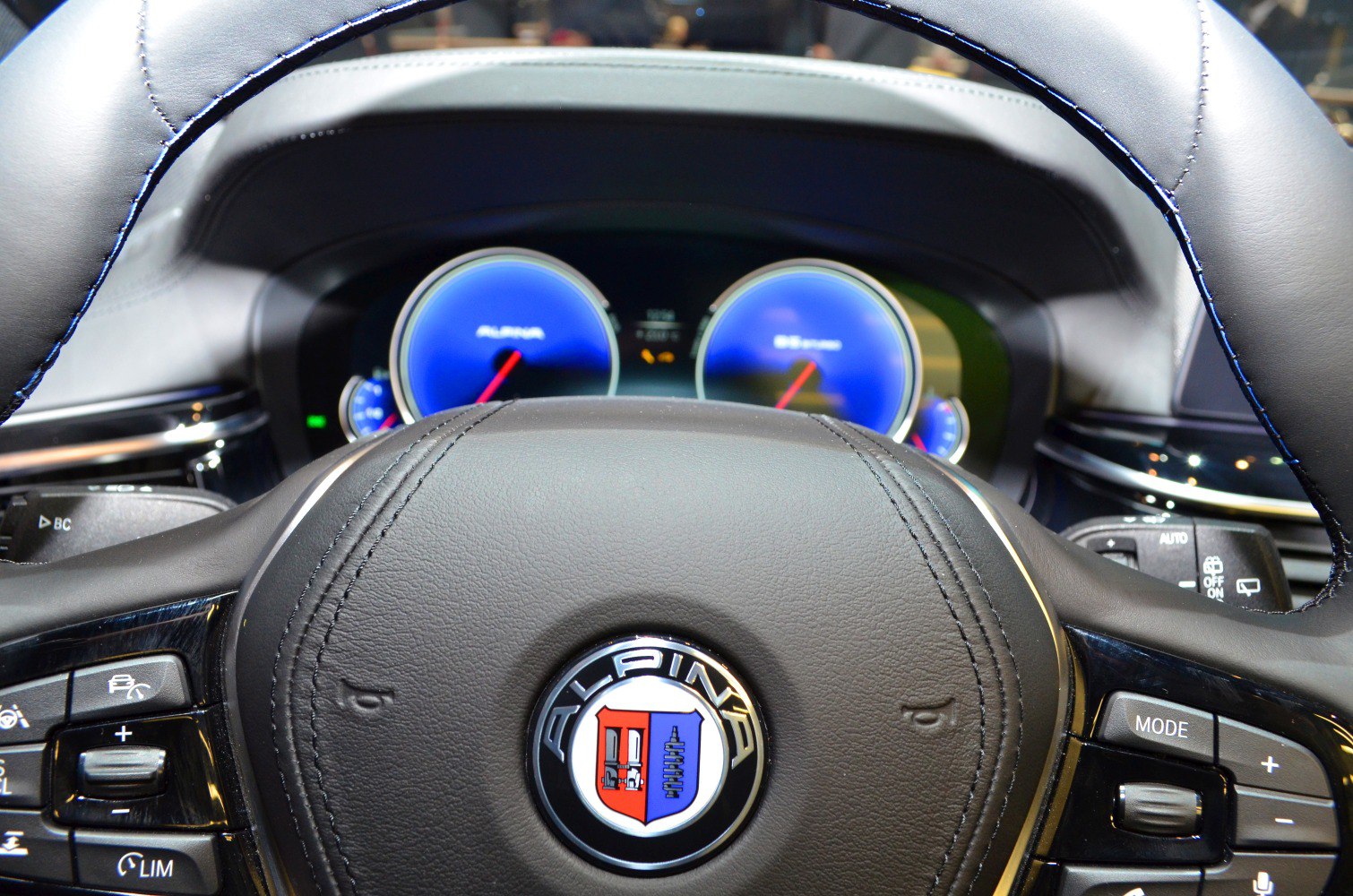 Alpina steering wheel with logo and digital instrument cluster illuminated in blue