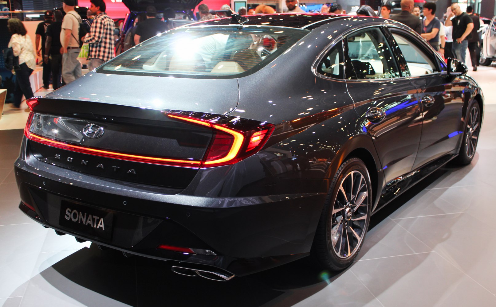 Rear design with LED tail lights and dual exhaust pipes on a modern sedan.