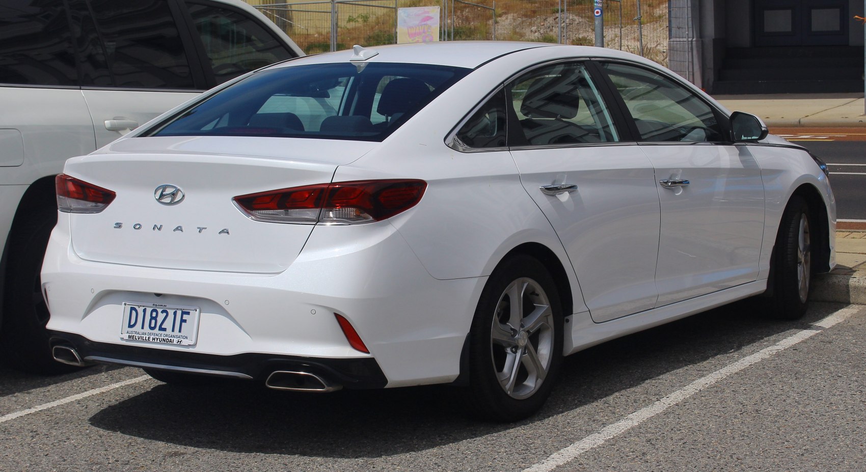 Rear view with distinctive tail lights and dual exhaust tips