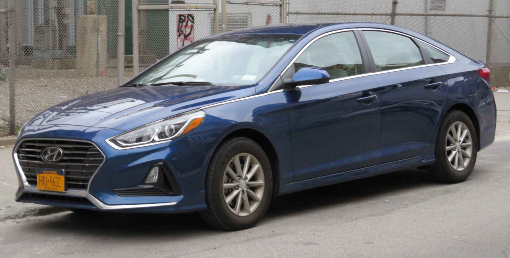 Front side view showcasing sleek headlights and alloy wheels.
