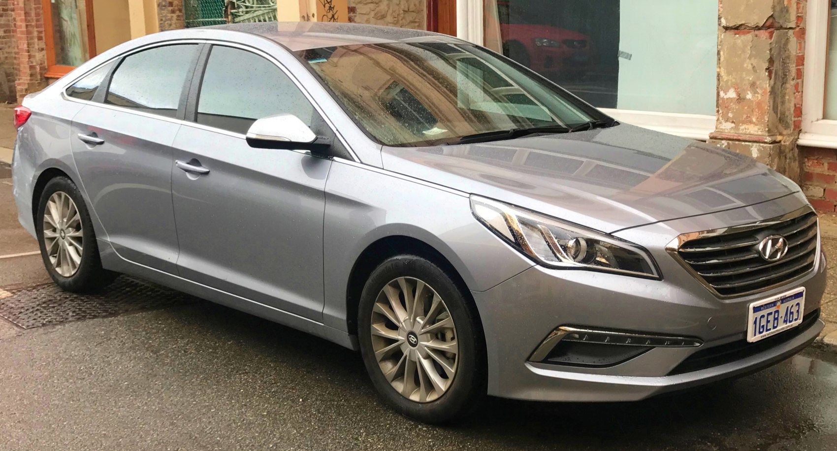 Front side view with alloy wheels and sleek sedan profile
