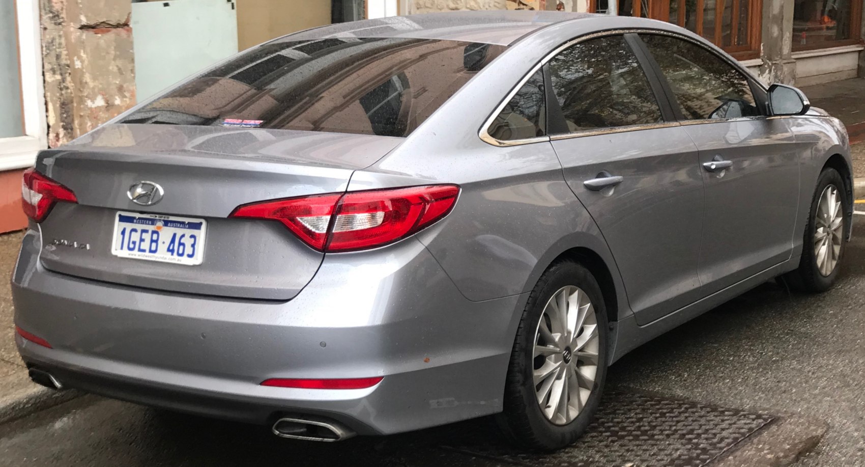 Rear side view with tail lights and dual exhaust pipes