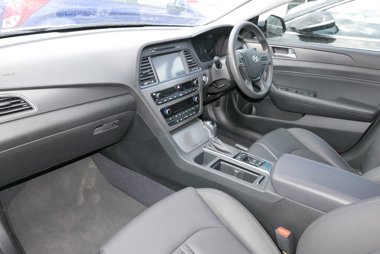Modern car interior with dashboard, center console, and steering wheel