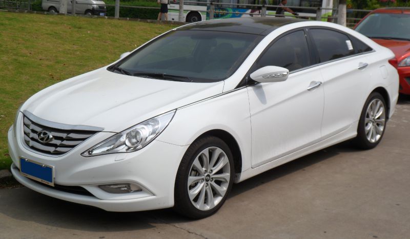 White sedan front-side view with alloy wheels and sleek design