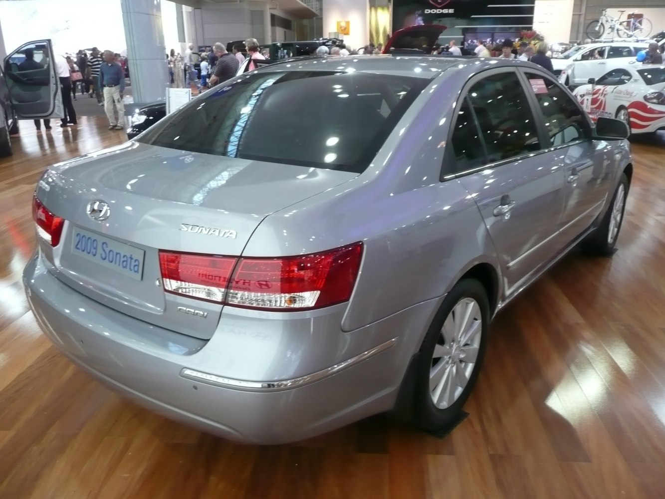 Rear side view of silver mid-size sedan with distinct taillights and alloy wheels