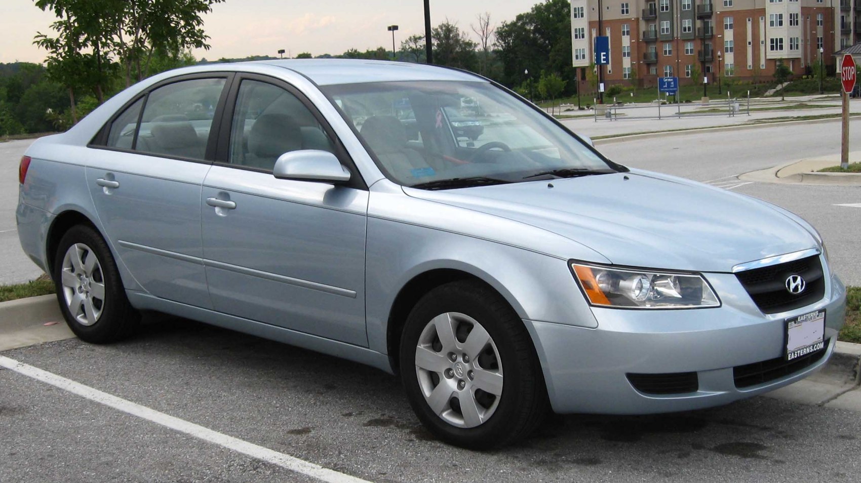 Silver four-door sedan front-side view with alloy wheels