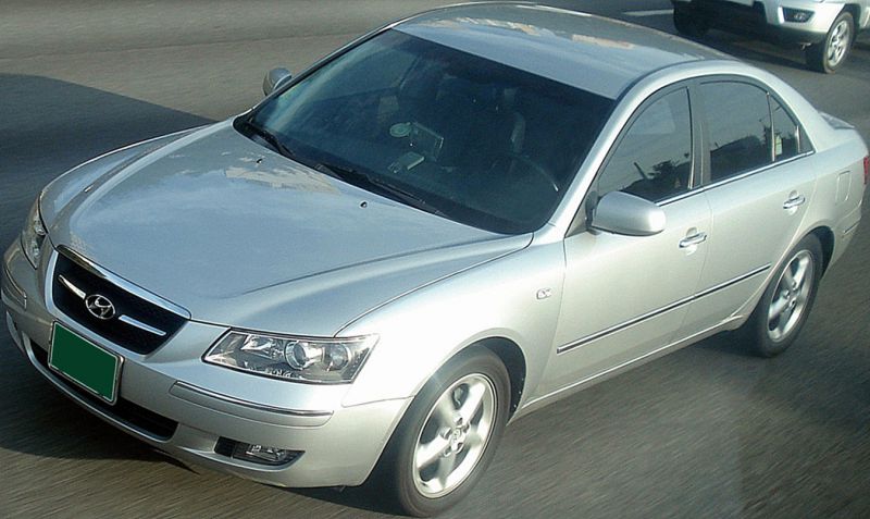 Front-side view of silver sedan with clear headlights and alloy wheels
