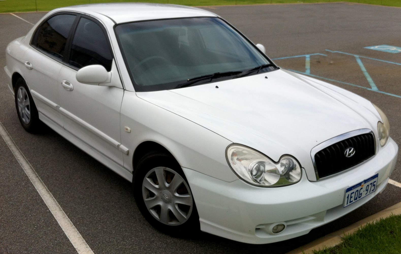 White sedan with distinctive rounded headlights and black grille