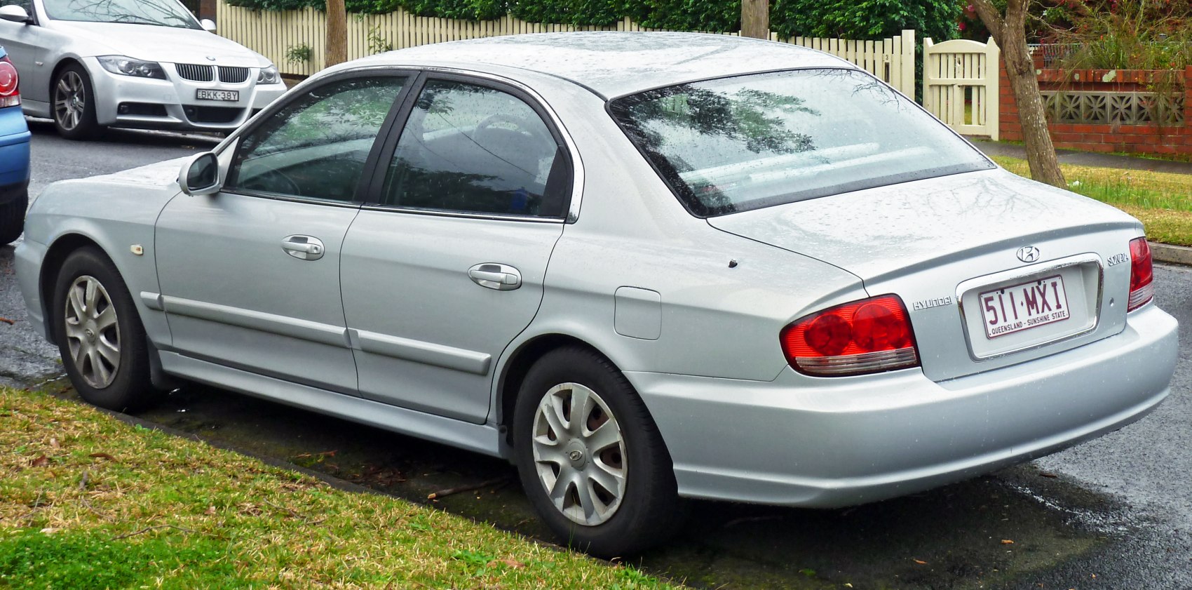 Silver mid-size sedan rear-side view with tail lights and smooth body lines