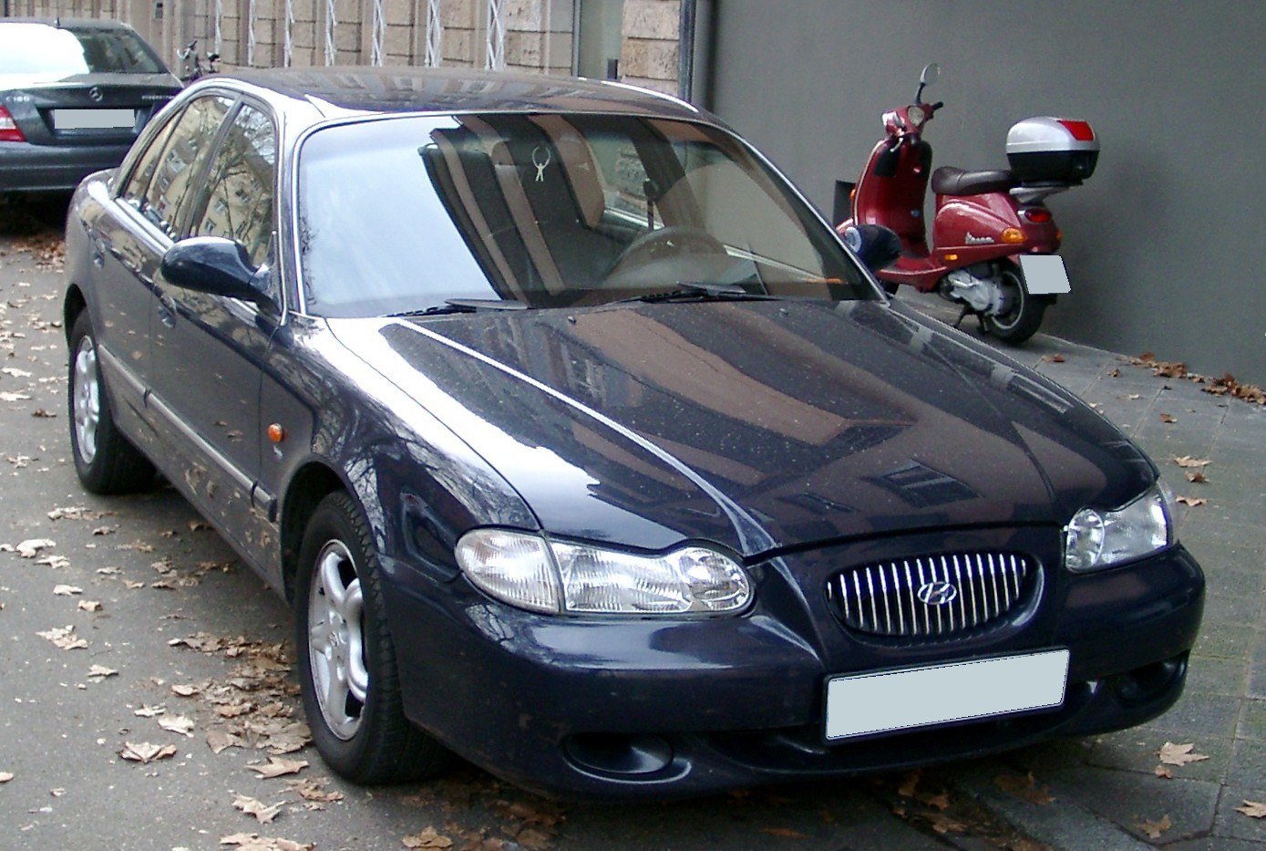 Front angled view of a sedan with unique headlight and grille design