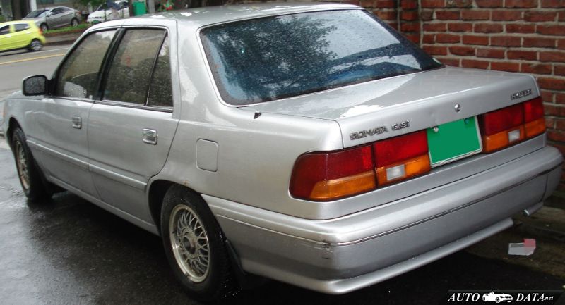 Rear and side view of silver sedan with distinctive taillights and BBS-style wheels.