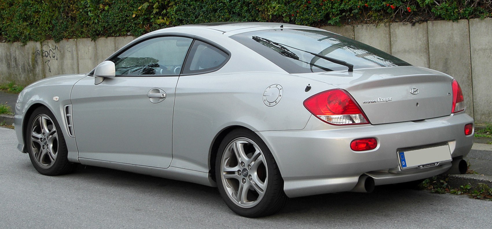 Silver coupe rear and side profile with distinct taillights and alloy wheels