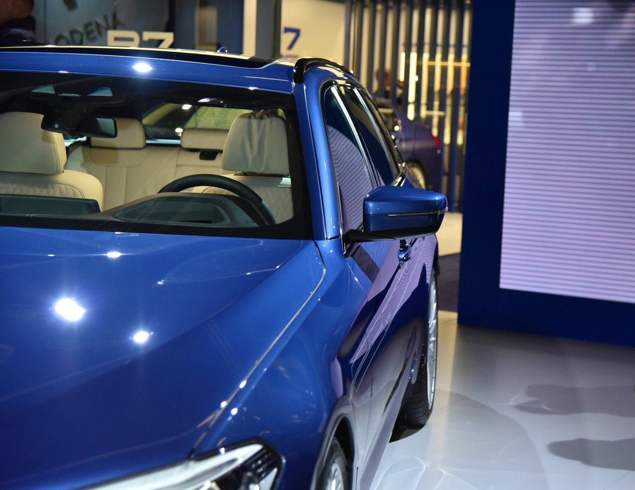 Blue car exterior with beige interior and side mirror detail