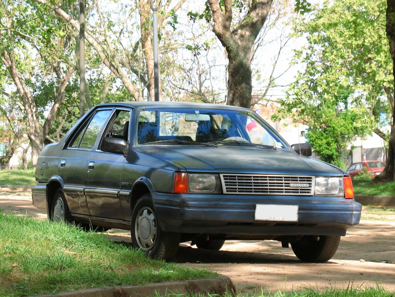 Classic sedan with boxy design, front grille, headlights and side view.