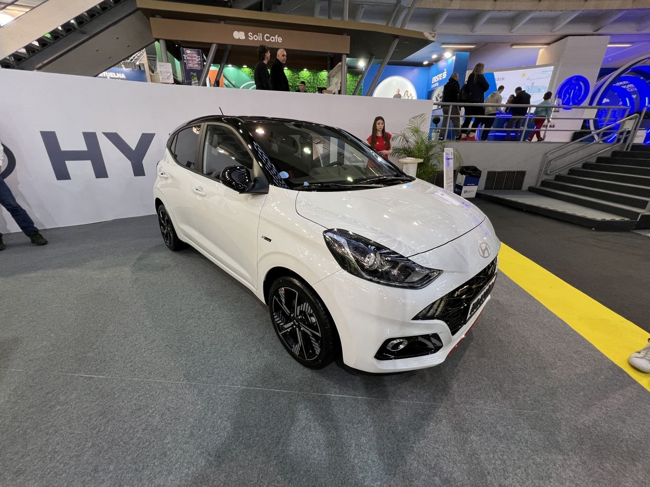 White compact hatchback with black roof and sporty alloy wheels