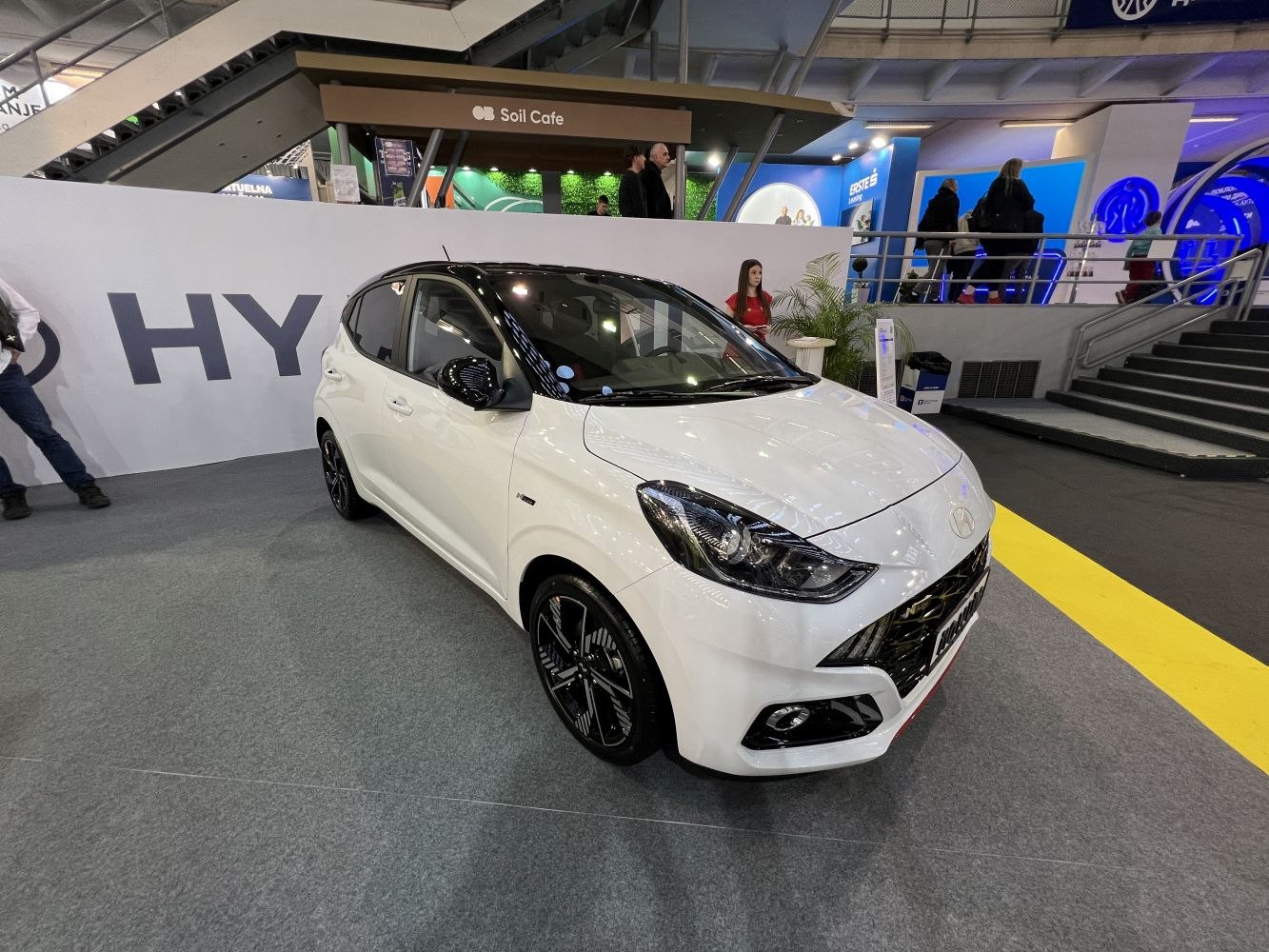 Front-side view of a hatchback with modern headlights and sporty wheels