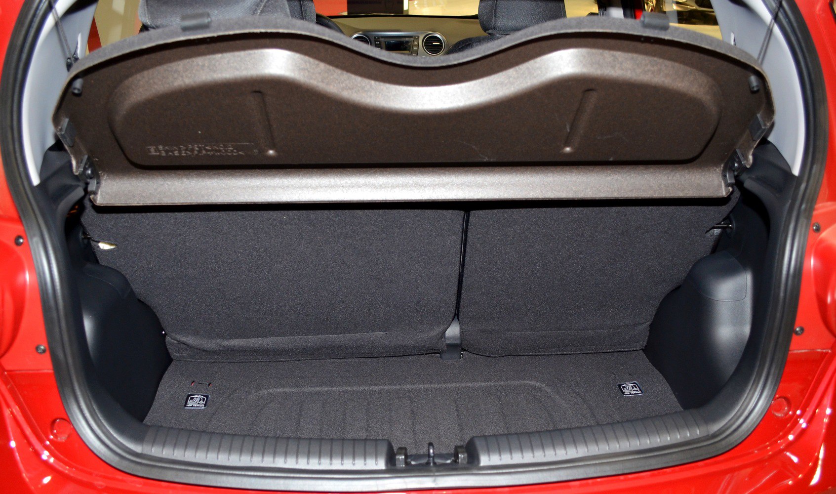 Open trunk area showing compact hatchback rear storage with foldable seats