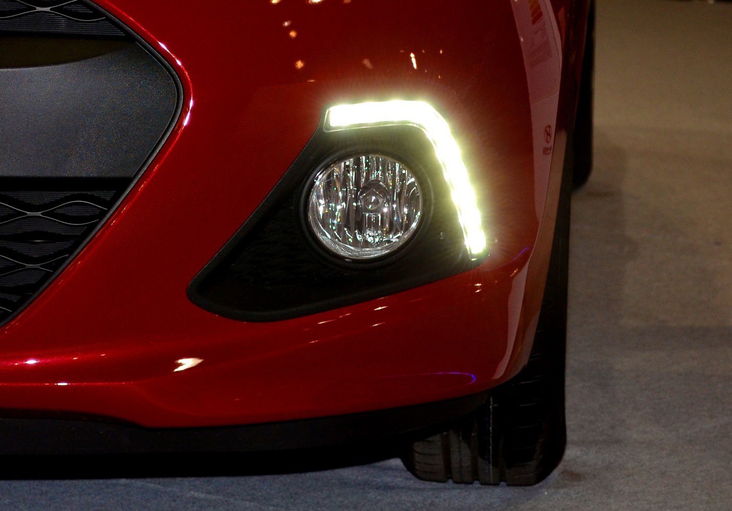 Front fog light with LED daytime running light on red vehicle bumper