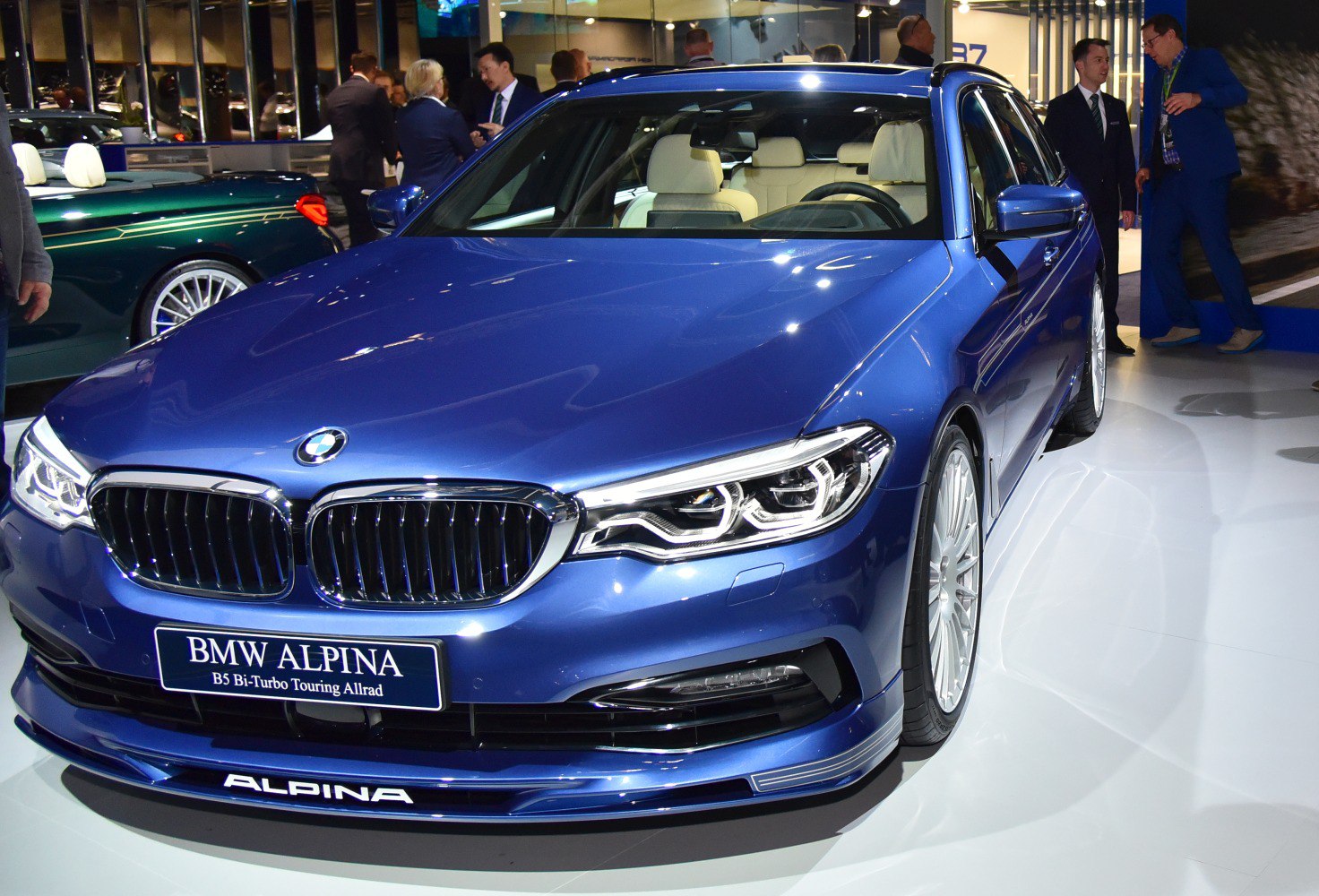 Front close-up of a blue luxury wagon with kidney grille and LED headlights
