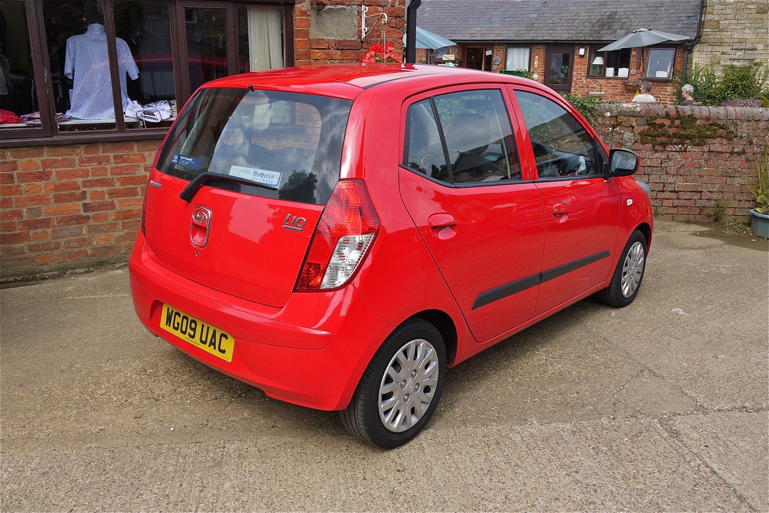 Rear and side view of compact hatchback with distinct taillights and rear wiper