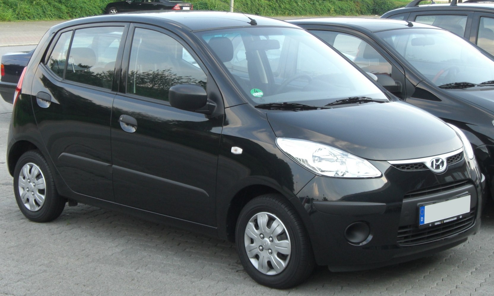 Compact black five-door hatchback with distinctive front grille and headlights