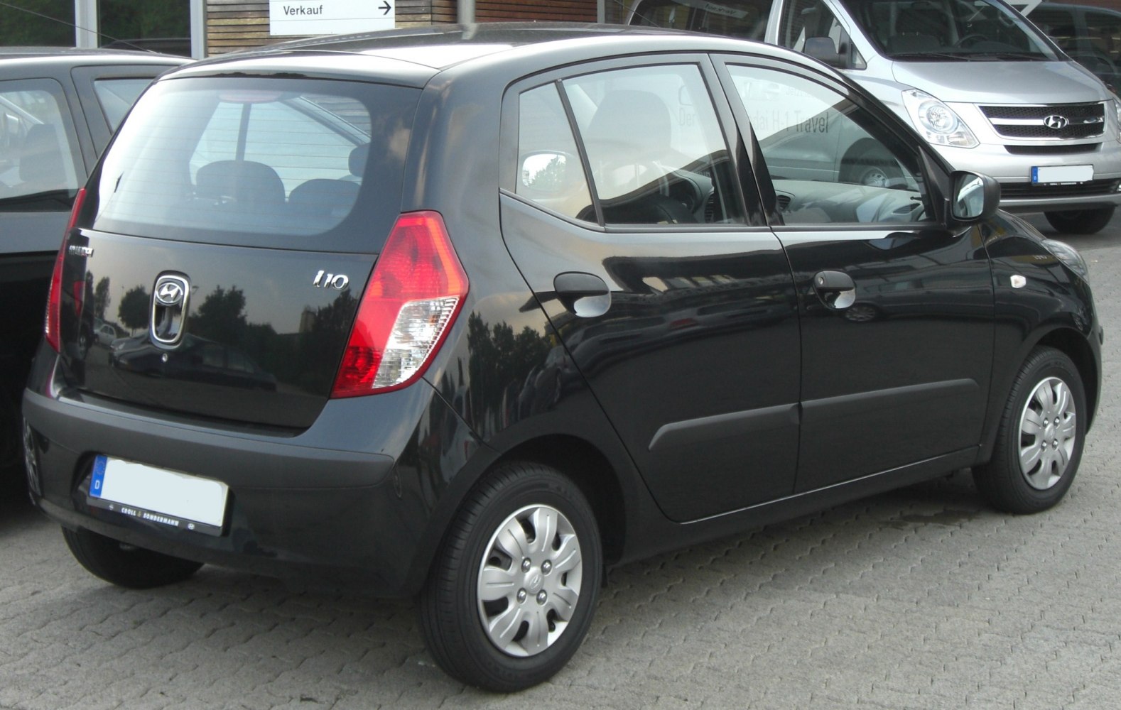 Rear side view with distinct taillights and small alloy wheels