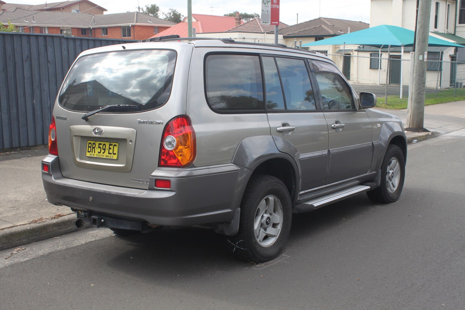 Rear and side view of a silver SUV with distinctive taillights and alloy wheels